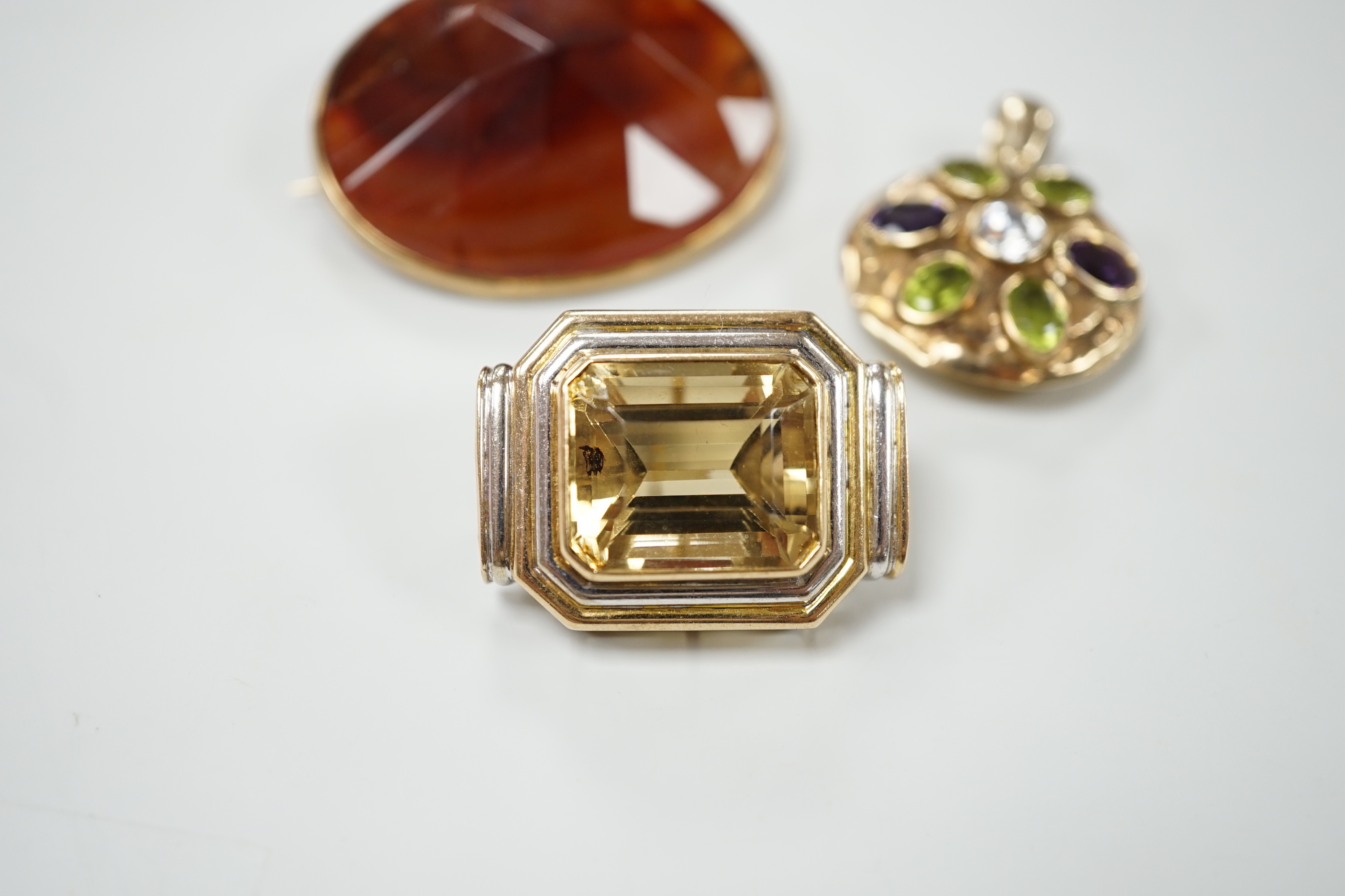 A modern 9ct gold, peridot, amethyst and simulated diamond cluster set circular pendant, diameter 27mm, together with a 9k and citrine set brooch and a yellow metal and facetted agate set brooch.